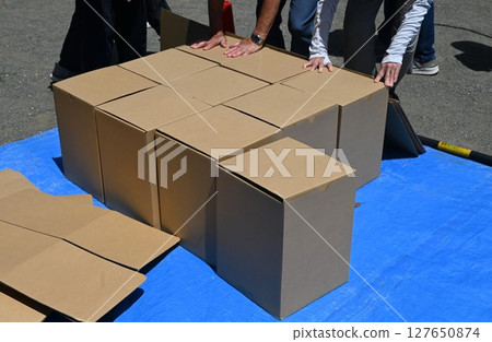 Disaster prevention training/assembly of cardboard beds for evacuation shelters 127650874