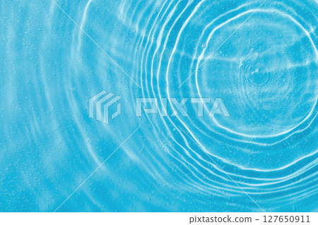 drops on water with circles on a blue background 127650911
