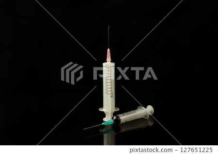 Syringe isolated on black background. Concept healthy and beauty. Syringe isolated on black background. Concept healthy and beauty. 127651225