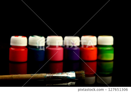 Artistic brushes close up. Watercolor paints in the background. Background with brushes and paints. 127651306