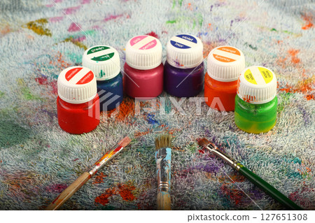 Artistic brushes close up. Watercolor paints in the background. Background with brushes and paints. Artistic brushes close up. Watercolor paints in the background. Background with brushes and paints. 127651308