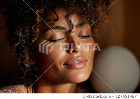 Peaceful female face with soft light and natural expression Peaceful female face with soft light and natural expression 127651467