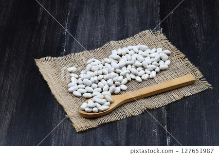 white kidney bean in wooden bowl isolated on wooden background. Top view. Flat lay 127651987