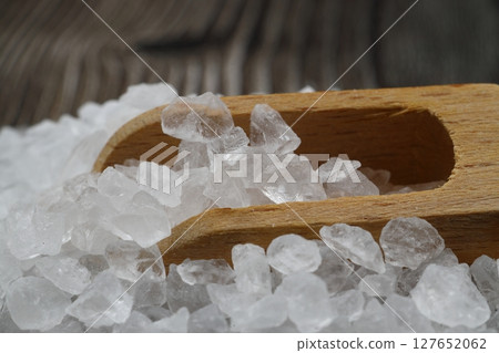 sea salt in a spoon isolated on black background 127652062