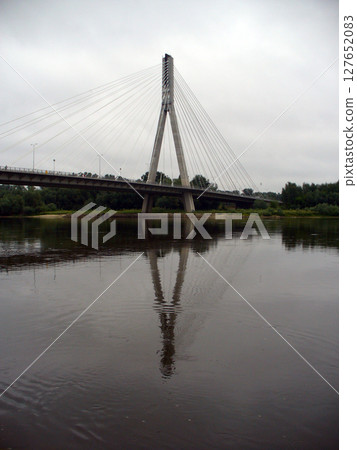 white bridge with pylons over the river white bridge with pylons over the river 127652083
