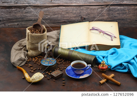 Turkish coffee concept. Copper pot (Cezve), vintage coffee grinder, coffee beans on a dark wooden background. Arab Turkish east coffee top view on dark wood background 127652096