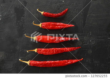 fresh chili peppers on black background,ripe red chili peppers. Top view. Mexican cuisine 127652255