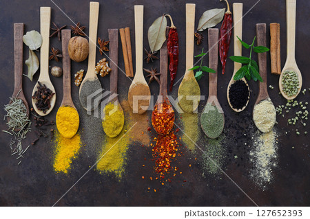 Different kind of spices on a wood background. Big set of Indian spices on wooden table. Different kind of spices on a wood background. Big set of Indian spices on wooden table. 127652393
