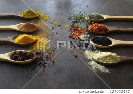 Different kind of spices on a wood background. Big set of Indian spices on wooden table. Top view, 127652427