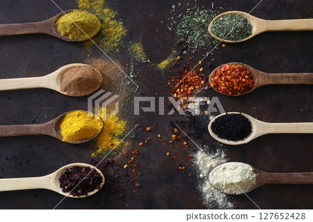 Different kind of spices on a wood background. Big set of Indian spices on wooden table. Top view, Different kind of spices on a wood background. Big set of Indian spices on wooden table. Top view, 127652428