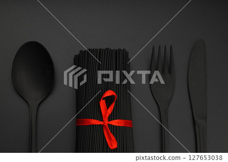 Raw black homemade spaghetti bunch isolated. Dry black noodles macaroni bundle. Close-up Raw black homemade spaghetti bunch isolated. Dry black noodles macaroni bundle. Close-up 127653038