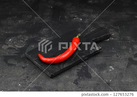 fresh chili peppers on black background,ripe red chili peppers. Top view. Mexican cuisine. Free space for text fresh chili peppers on black background,ripe red chili peppers. Top view. Mexican cuisine. Free space for text 127653276