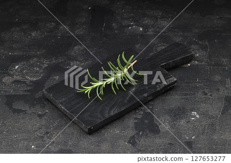 Dry organic background or texture of rosemary leaves. Healthy food concept . a wooden spoon with rosemary, a kind of green color and very fine sticks. leaning on a brown table. Dry organic background or texture of rosemary leaves. Healthy food concept . a wooden spoon with rosemary, a kind of green color and very fine sticks. leaning on a brown table. 127653277