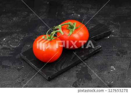 Fresh cherry tomatoes on a black background. Bunch of fresh cherry tomato on a black background Fresh cherry tomatoes on a black background. Bunch of fresh cherry tomato on a black background 127653278