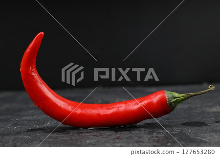 fresh chili peppers on black background,ripe red chili peppers. Top view. Mexican cuisine. Free space for text fresh chili peppers on black background,ripe red chili peppers. Top view. Mexican cuisine. Free space for text 127653280