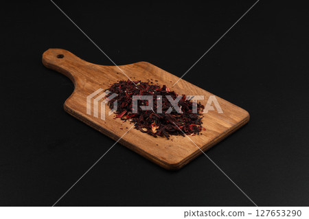 Hibiscus, a pile of red dried Hibiscus tea leaves. Karkade tea. On white background. View from above. 127653290