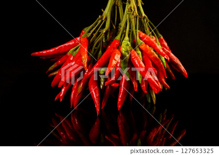 Bunch of fresh small red pepper isolated on black background 127653325