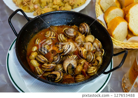 Grape snails in sauce. Spanish dish Grape snails in sauce. Spanish dish 127653488