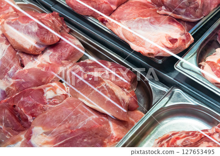 Raw pork on display in butcher shop 127653495