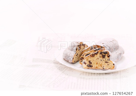 Stollen, German sweet bread, cut, cross section, light background Stollen, German sweet bread, cut, cross section, light background 127654267