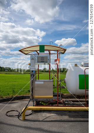 Propane gas station with large storage tank in rural countryside area Propane gas station with large storage tank in rural countryside area 127654599
