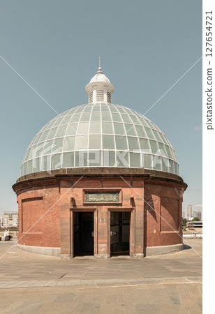 the iconic entrance to the Greenwich Foot Tunnel are characterized by their elegant brickwork and glass domes. 127654721