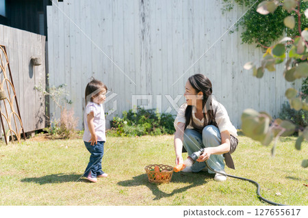 Parents and children playing in a garden full of nature Parents and children playing in a garden full of nature 127655617