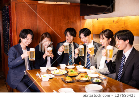 Drinking party: Young people toasting at an izakaya 127656425