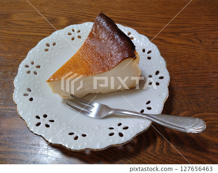 Basque cheesecake on a white plate 127656463