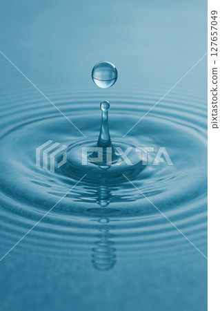 The moment when a drop of water hits the water surface and ripples spread The moment when a drop of water hits the water surface and ripples spread 127657049