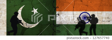 Conflict between India and Pakistan concept. Political tension between India and Pakistan. Pakistan vs India flag on cracked wall 127657740