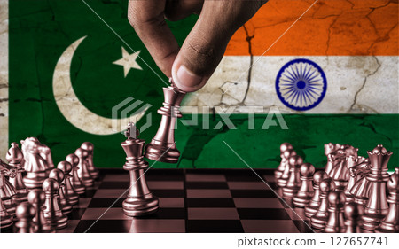 India vs Pakistan flag concept on chessboard. War between Pakistan and India. Conflict between Pakistan and India on pieces of chessboard 127657741