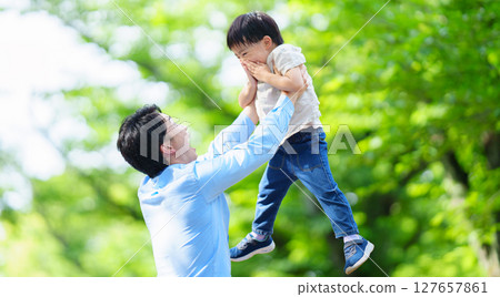 Father lifting up his 5 year old son Father lifting up his 5 year old son 127657861