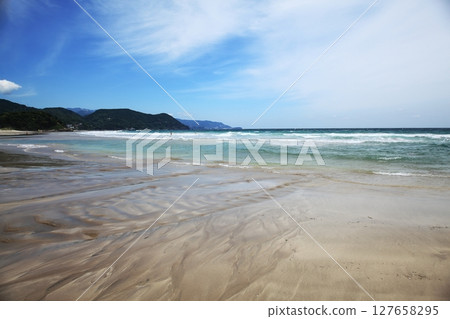 White sand beach and blue sea 127658295