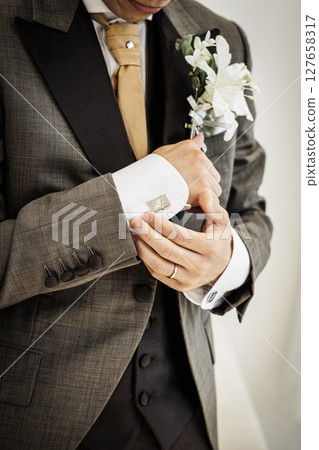 Close-up photo of the groom's chest in a black tie Close-up photo of the groom's chest in a black tie 127658317
