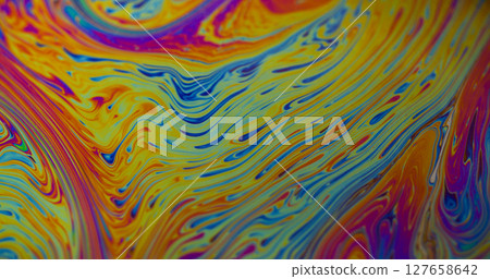 Fuel spilling. Iridescent art. Blur yellow blue purple color flowing chemical paint water floating on abstract creative background. 127658642