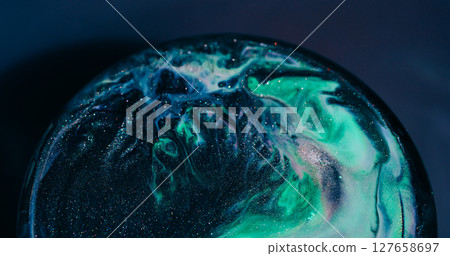 Wet shimmering. Acrylic spill. Black green sparkling paint mixing abstract color circle. Pigment texture defocused background. 127658697