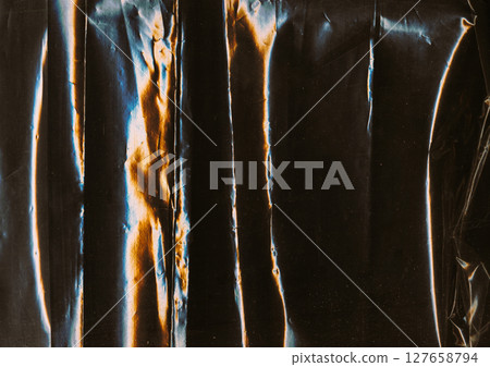 Creased overlay. Old film texture. Blue orange color light flare dust scratches used weathered rough foil noise dark black art abstract background. Creased overlay. Old film texture. Blue orange color light flare dust scratches used weathered rough foil noise dark black art abstract background. 127658794