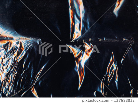Creased overlay. Old film texture. Blue orange color light flare dust scratches used weathered rough foil noise dark black art abstract background. 127658832