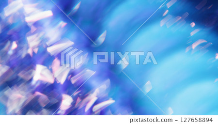 Crystal flare. Defocused particles. White gleaming twirling lens flare effect on blue purple smooth bokeh light background. 127658894