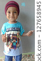 boy wearing maroon hat 127658945