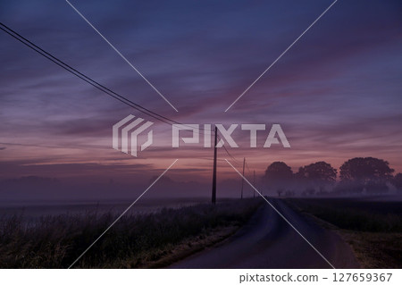 Serene Dawn A Misty Road Beauty at Sunrise, Perfect for Inspiring Adventurous Souls 127659367