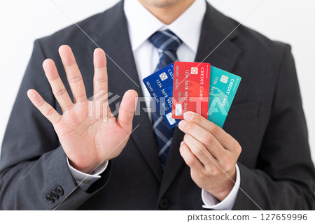A businessman in a suit holding a credit card and showing five fingers 127659996
