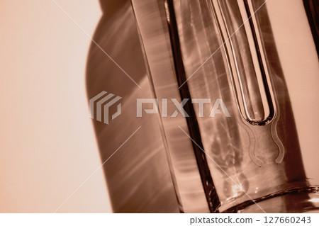 Dropper Bottle with cosmetic oil close-up in mocha mousse color Dropper Bottle with cosmetic oil close-up in mocha mousse color 127660243