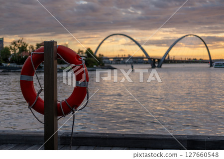 Elizabeth Quay during the sunset, a major waterfront precinct in Perth, Western Australia, situated on the Swan River. It is a hub for dining, entertainment and events. with swim ring on the foregroun 127660548