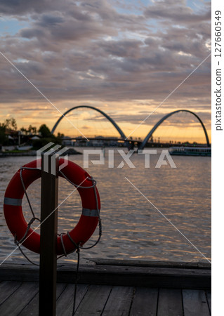 Elizabeth Quay during the sunset, a major waterfront precinct in Perth, Western Australia, situated on the Swan River. It is a hub for dining, entertainment and events. with swim ring on the foregroun Elizabeth Quay during the sunset, a major waterfront precinct in Perth, Western Australia, situated on the Swan River. It is a hub for dining, entertainment and events. with swim ring on the foregroun 127660549