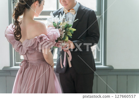 Western-style house, wedding hall, couple (groom, groom) taking wedding photos in pink dresses 127660557