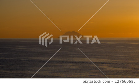 Stromboli Volcano emerging from the Tyrrhenian Sea at sunset, seen from Tropea, Calabria, Italy Stromboli Volcano emerging from the Tyrrhenian Sea at sunset, seen from Tropea, Calabria, Italy 127660683