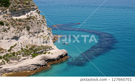 Tourists enjoying crystal clear turquoise water at Tropea beach, Calabria, Italy 127660701