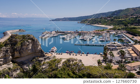 Tropea port with docked boats and cliff overlooking the Tyrrhenian Sea in Calabria, Italy 127660730